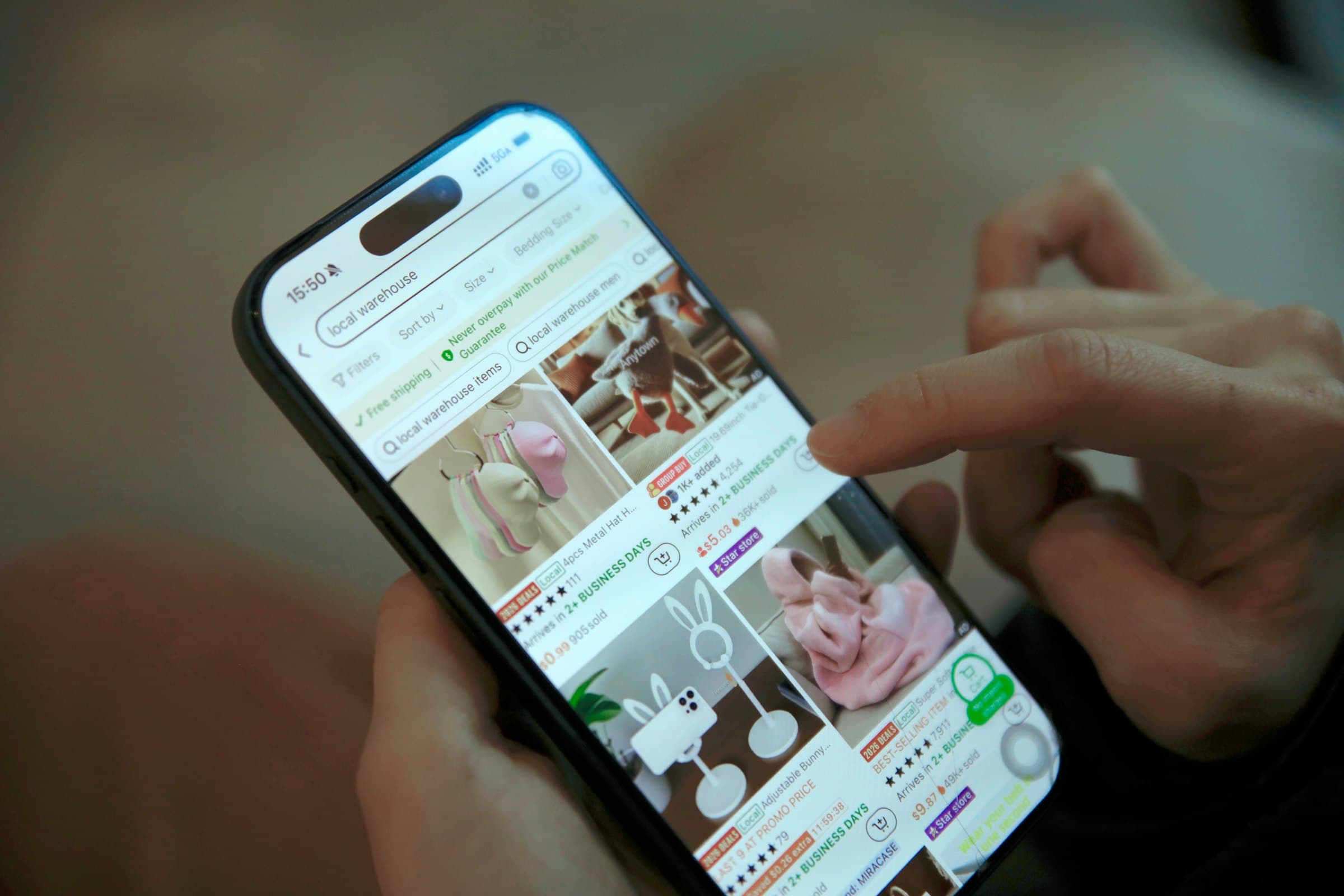 Person scrolling through online shopping on a smartphone
