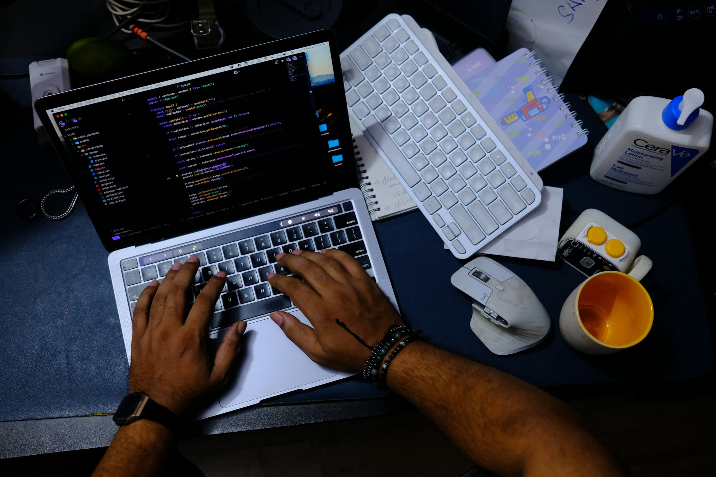 Close-up of a developer's hands typing code on a laptop
