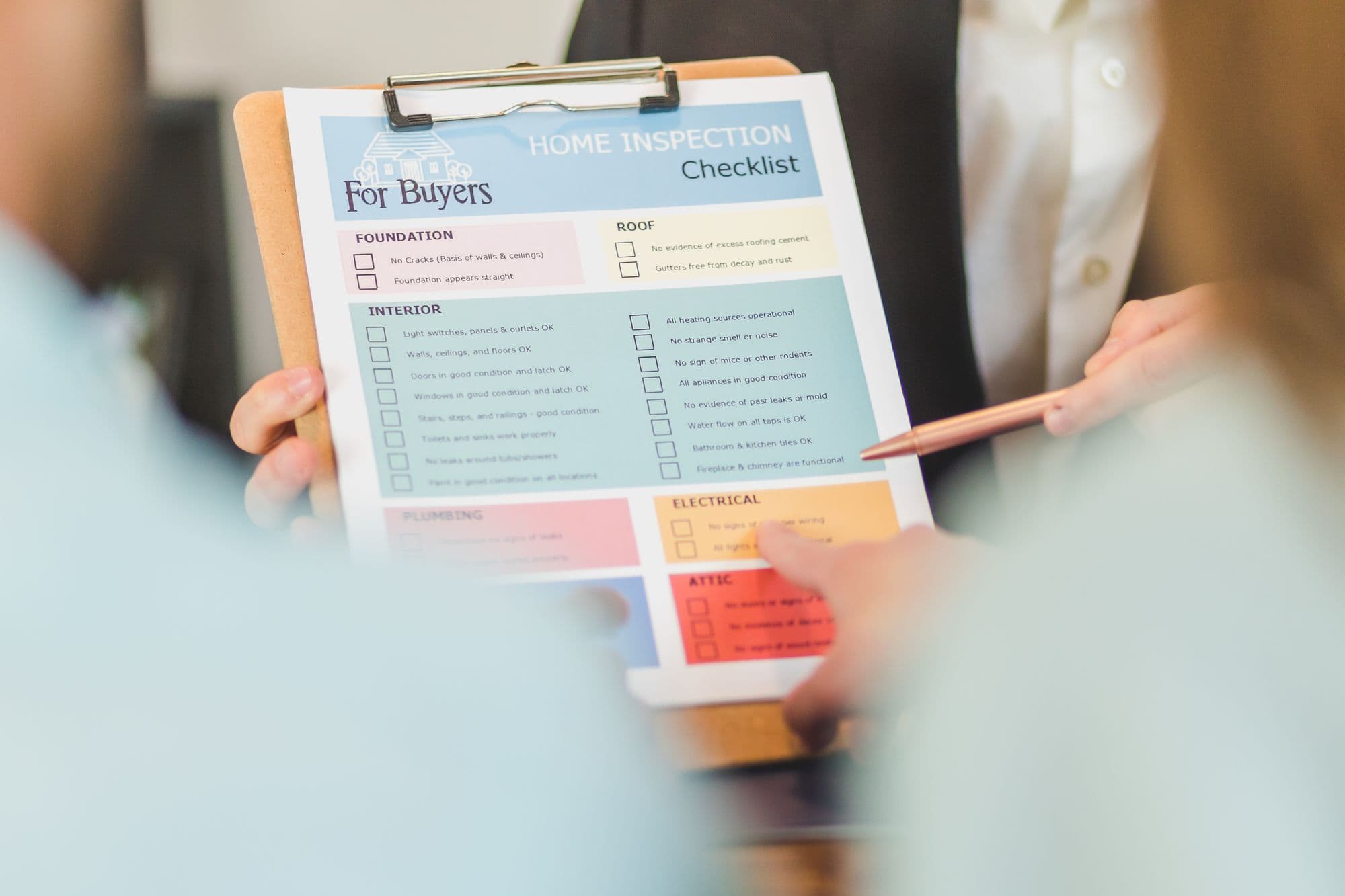 Hands holding a clipboard with a checklist